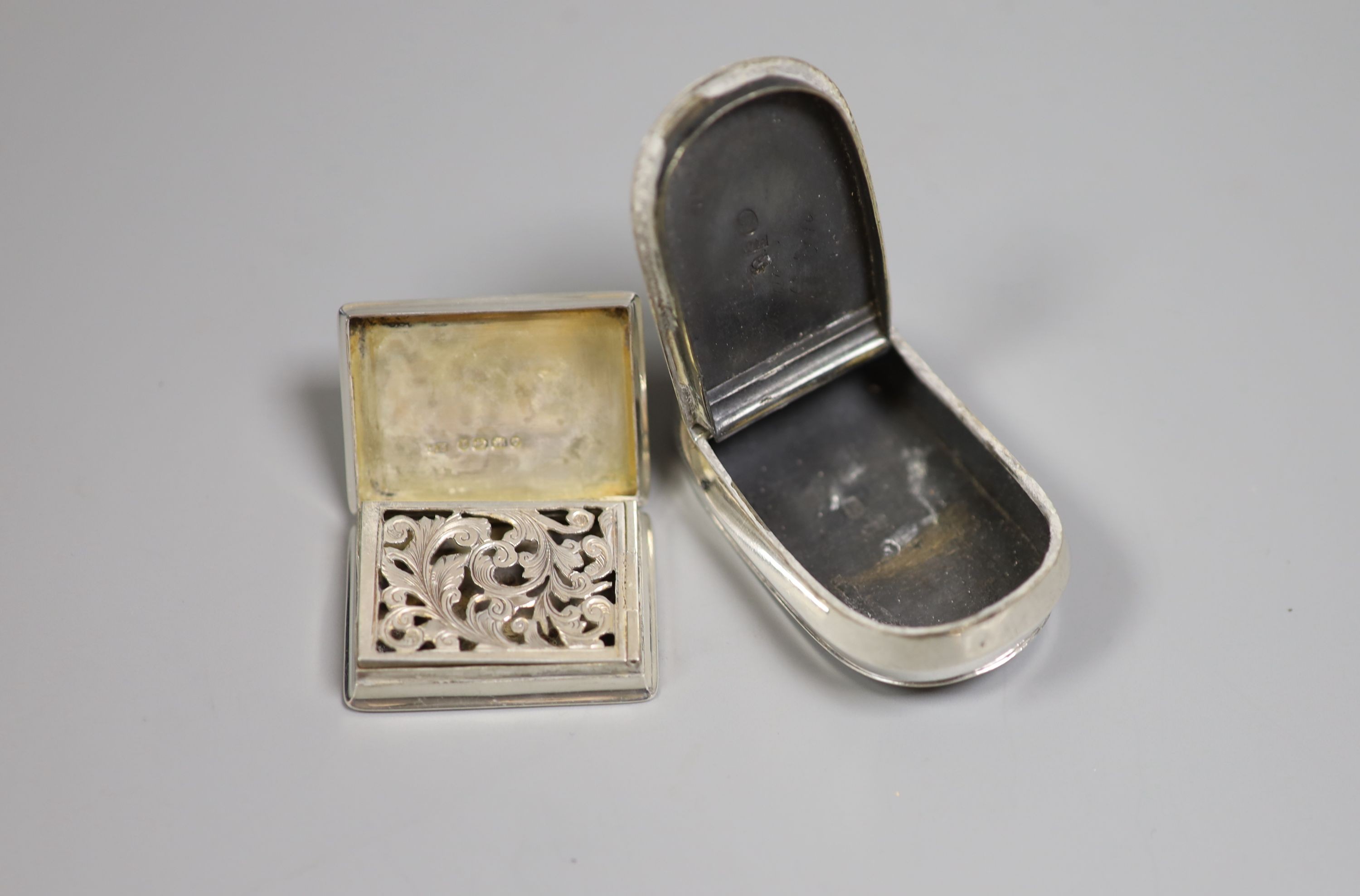 A George III silver curved snuff box, Birmingham, 1808, 7cm, a Victorian silver vinaigrette and a silver child's rattle.